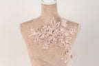 A mannequin with a delicate, floral-patterned fabric draped over it.