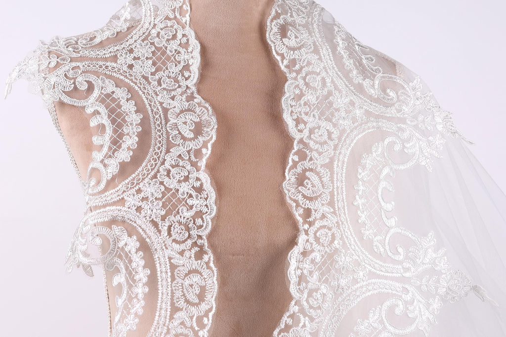 A close-up view of a delicate, lace-like fabric, possibly a wedding veil or a similar decorative piece.