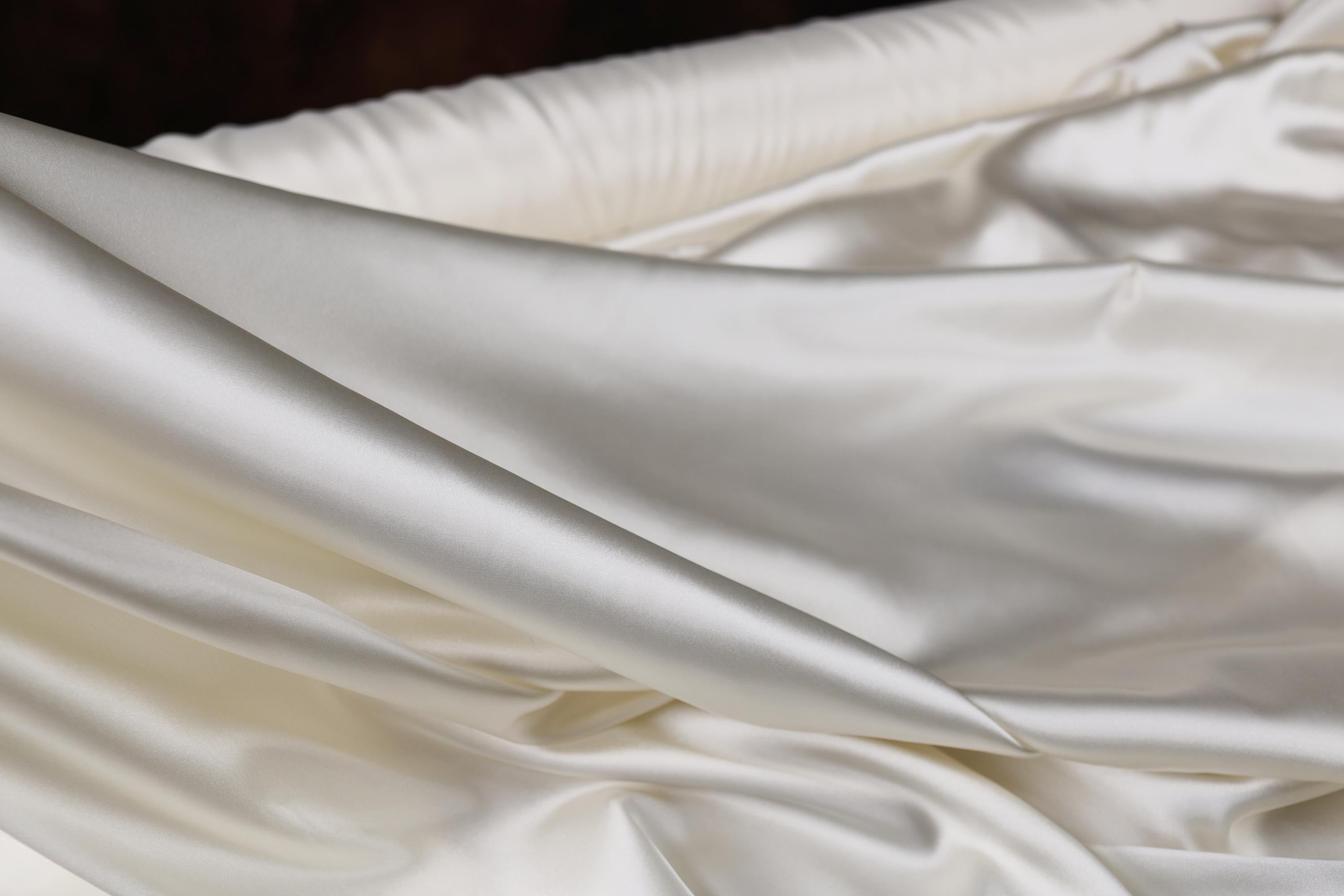 a close up of a white satin material