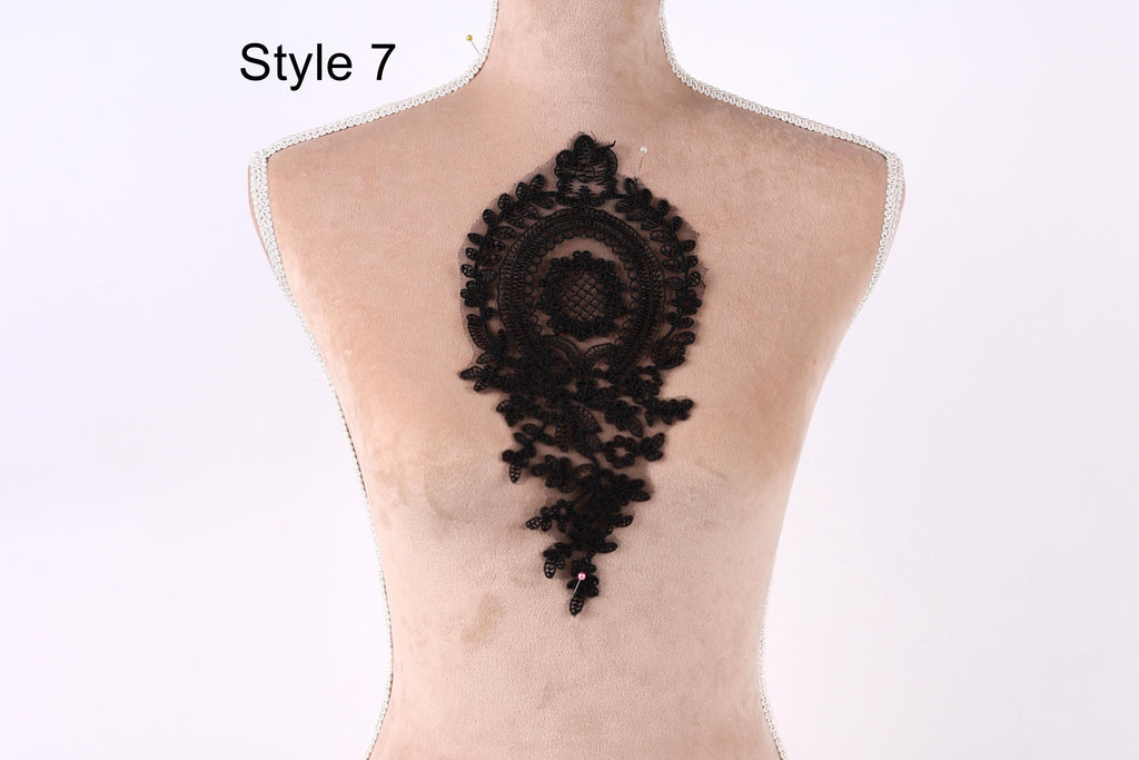 a mannequin with a black lace design on its back.