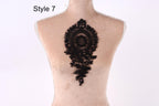 a mannequin with a black lace design on its back.
