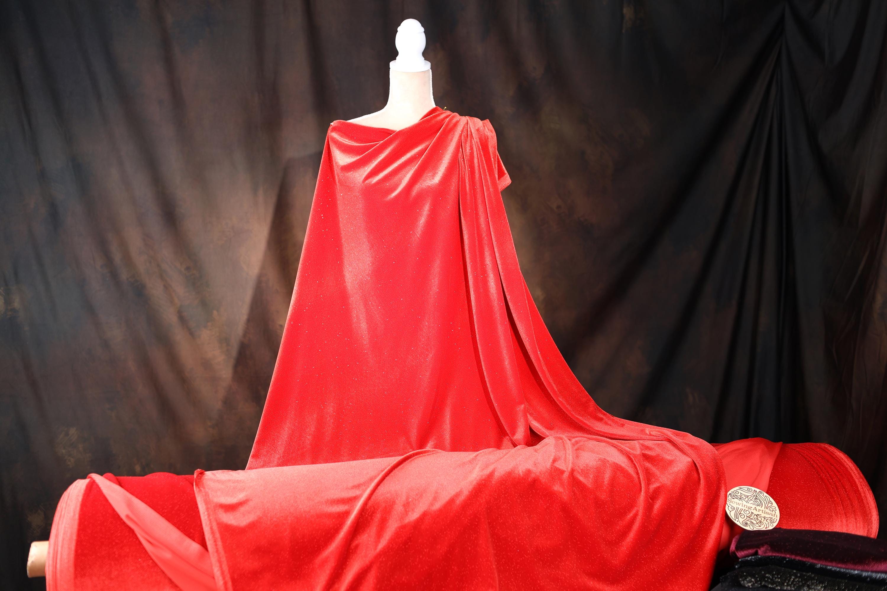 a mannequin dressed in a red cape and cloak