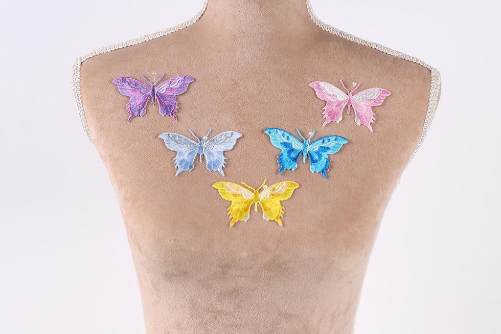 a mannequin with six colorful butterfly patches on its back.