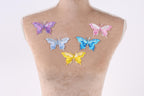 a mannequin with six colorful butterfly patches on its back.