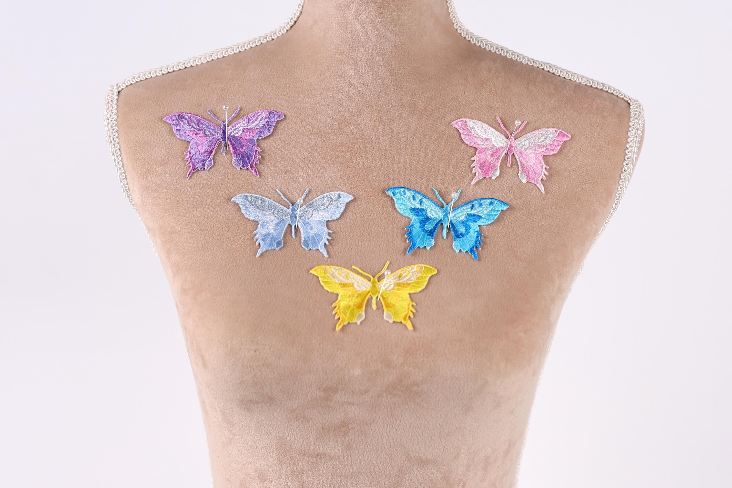 a mannequin with six colorful butterfly patches on its back.