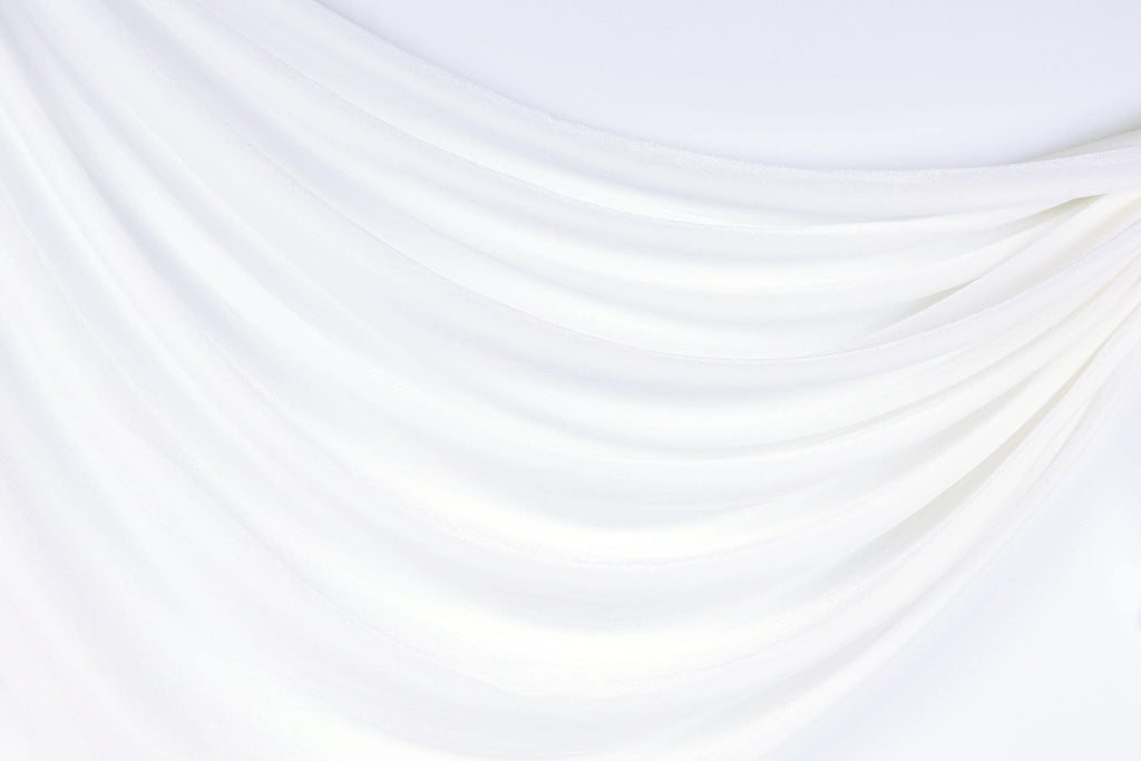The image is a white fabric with a curved, flowing texture, creating a sense of softness and elegance.