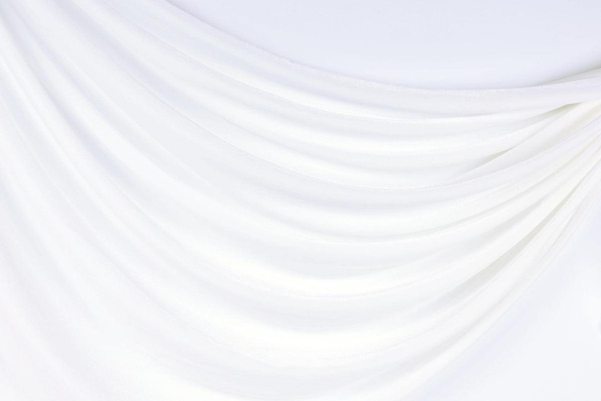 The image is a white fabric with a curved, flowing texture, creating a sense of softness and elegance.