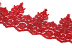 a close-up view of a red, intricately designed lace trim or border.