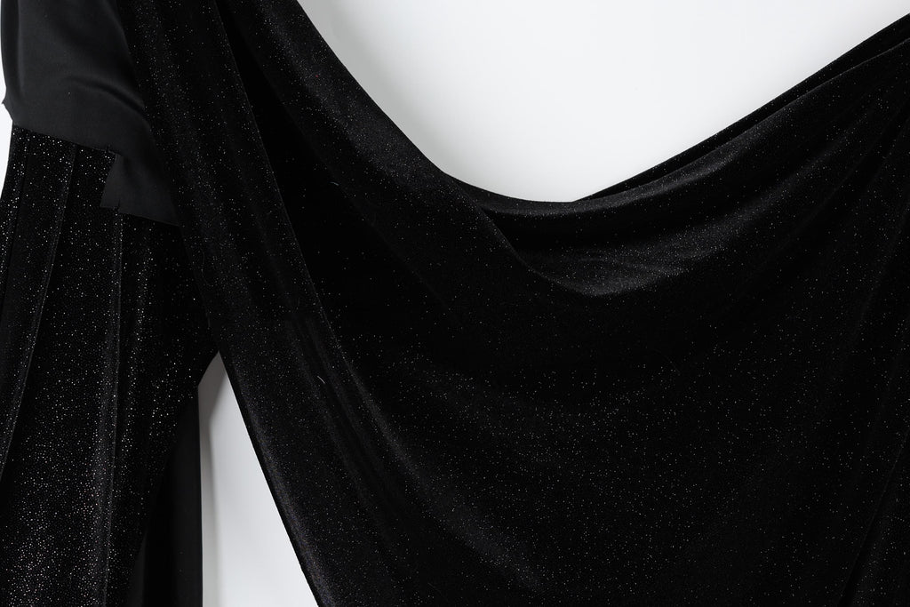 The image is a close-up of a black velvet fabric with a shiny, sparkly texture.