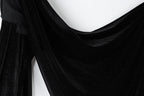 The image is a close-up of a black velvet fabric with a shiny, sparkly texture.