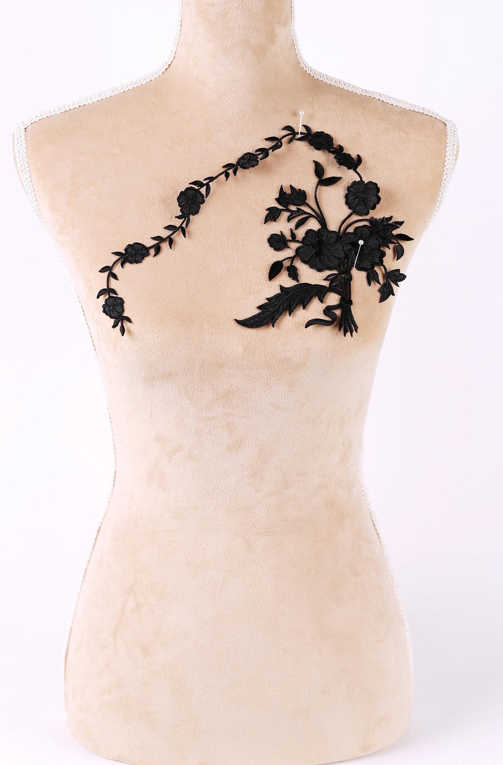 A mannequin with a floral embroidered patch on its bust.