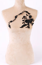 A mannequin with a floral embroidered patch on its bust.