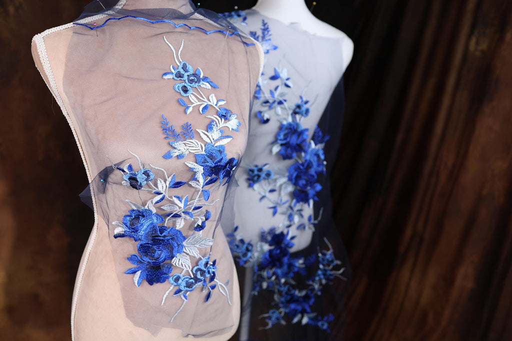 two mannequins with blue flowers on them
