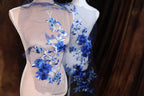 two mannequins with blue flowers on them