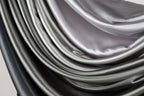 a close-up view of a fabric with a gradient of gray and black colors, creating a visually striking and textured appearance.