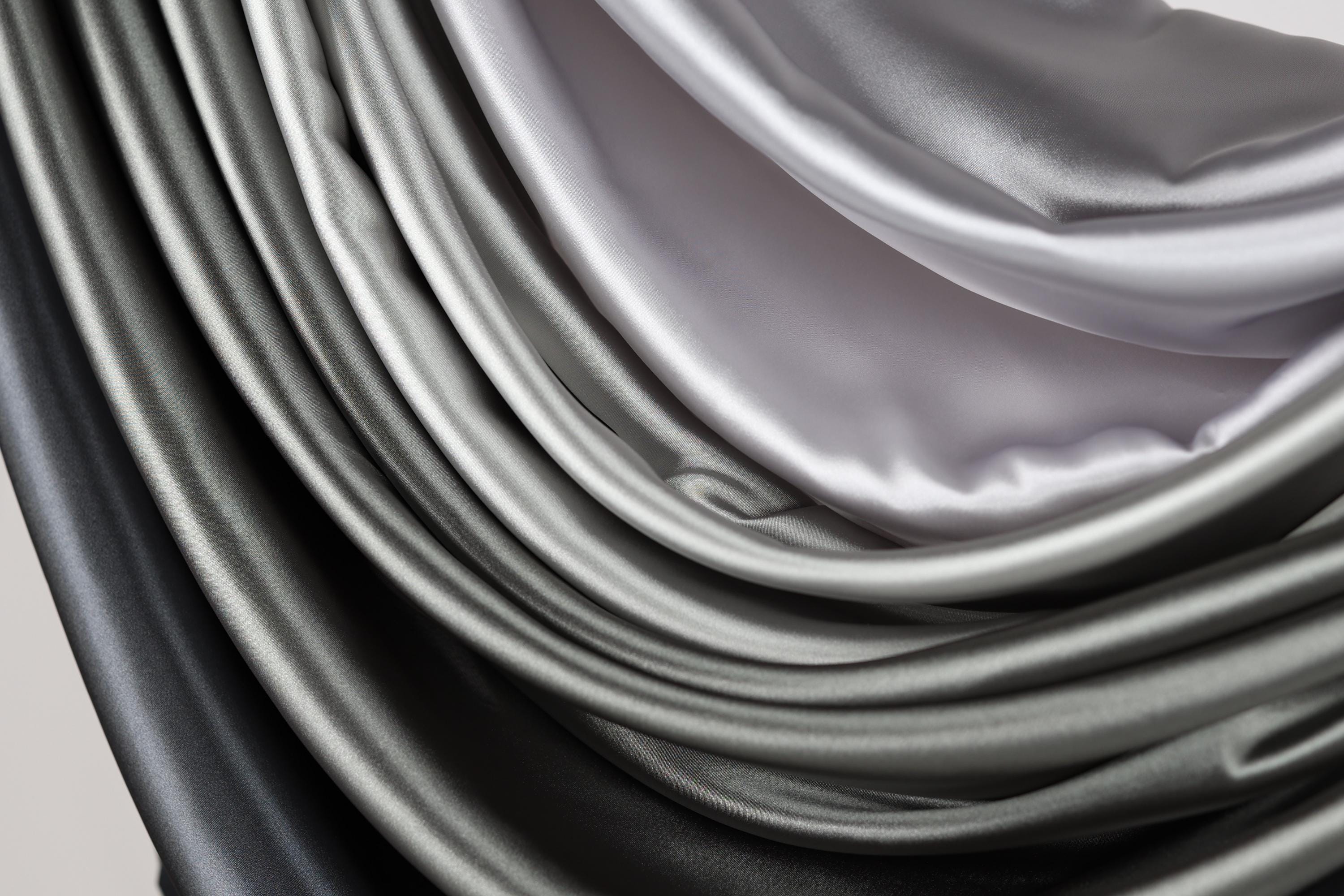 a close-up view of a fabric with a gradient of gray and black colors, creating a visually striking and textured appearance.