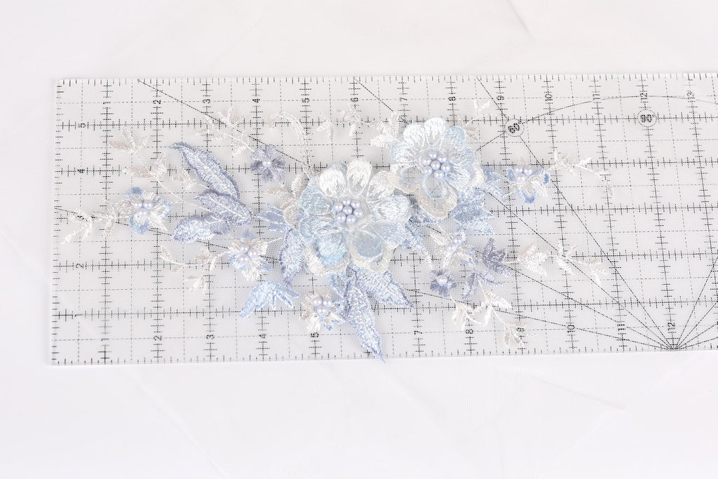 a clear ruler with a floral pattern on it, placed on a white surface.