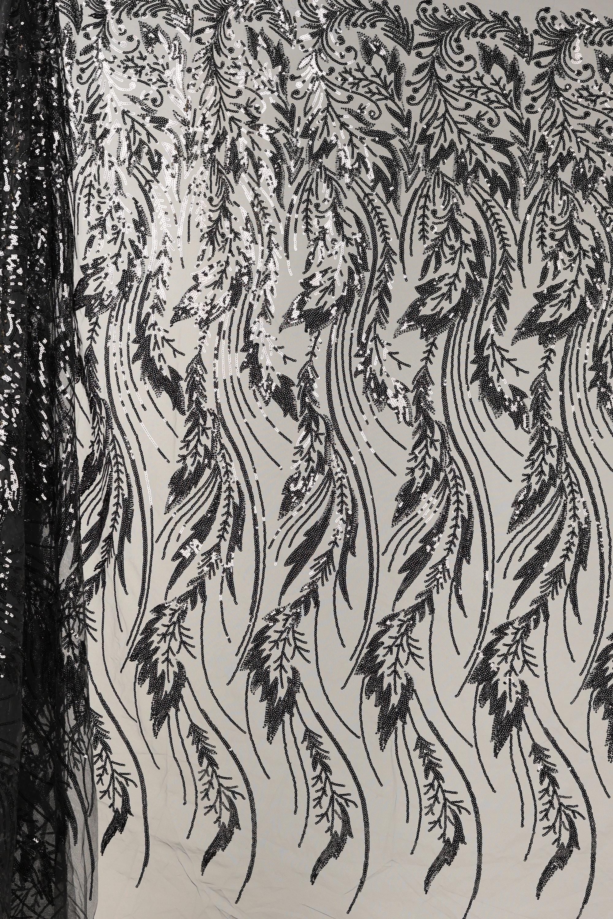 a close-up view of a fabric with a repeating pattern of black and white lines and shapes, resembling a floral or leaf-like design. The pattern appears to be intricate and detailed, with the lines and shapes varying in size and orientation, creating a visually striking and dynamic composition.