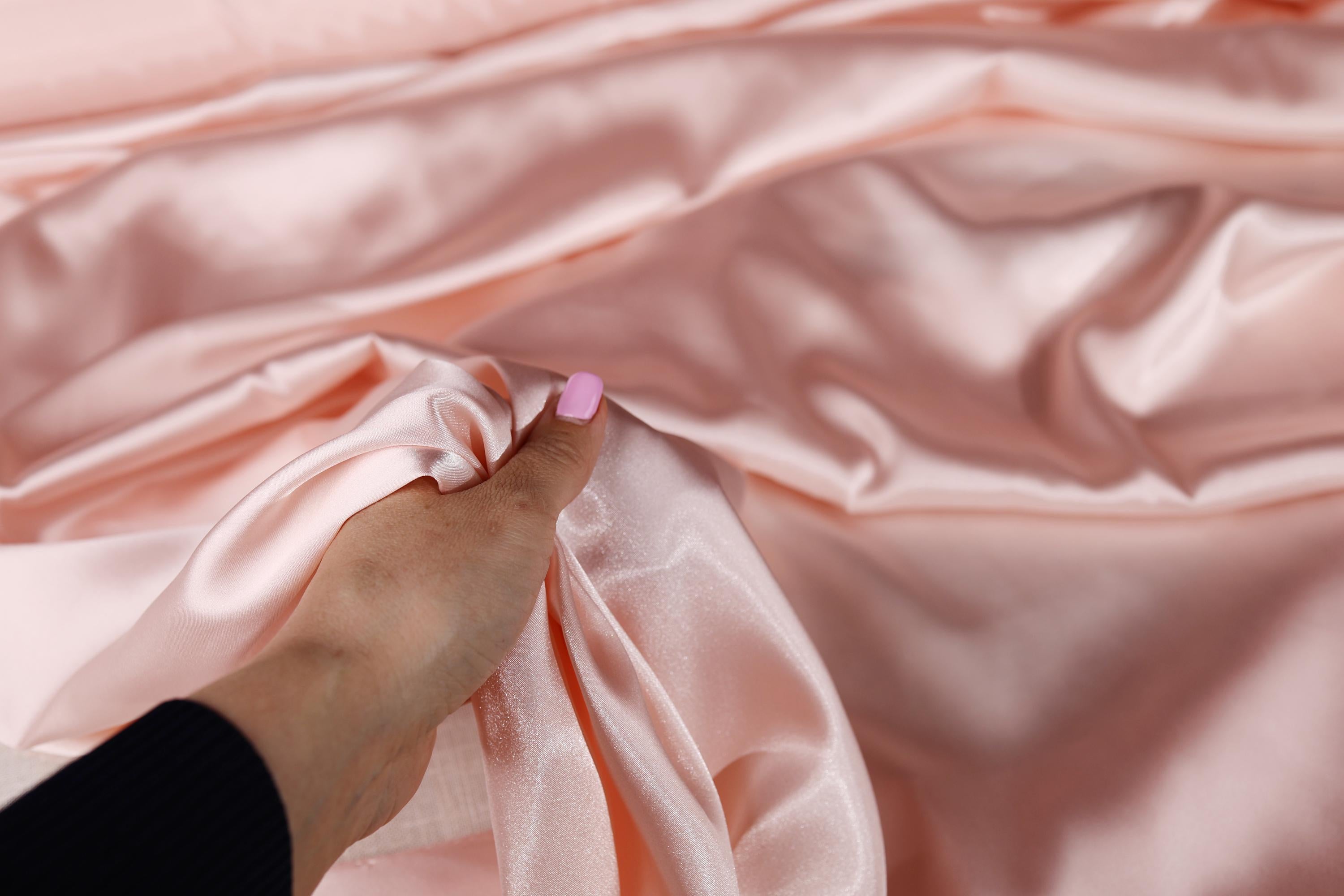 a person holding a pink object in their hand