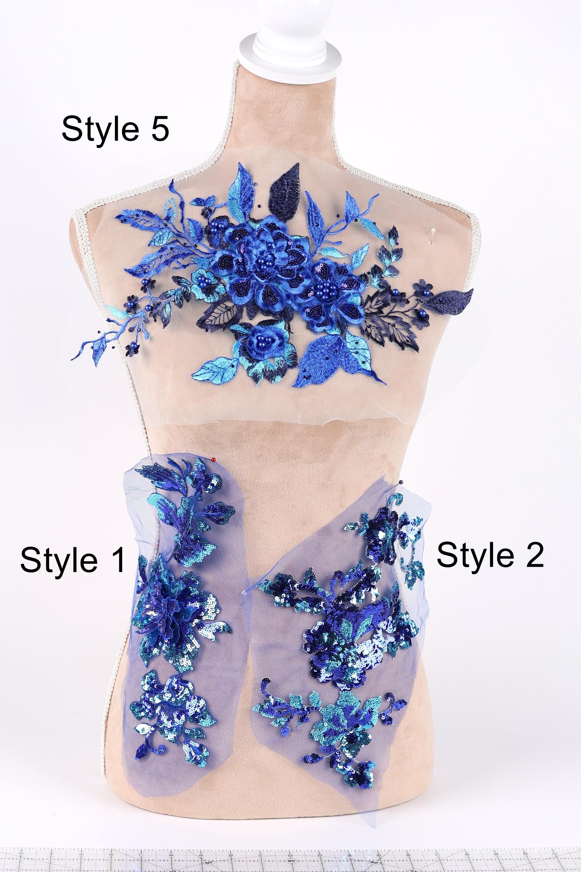 A mannequin with various blue floral and leaf designs on its bust area, displayed on a white background.