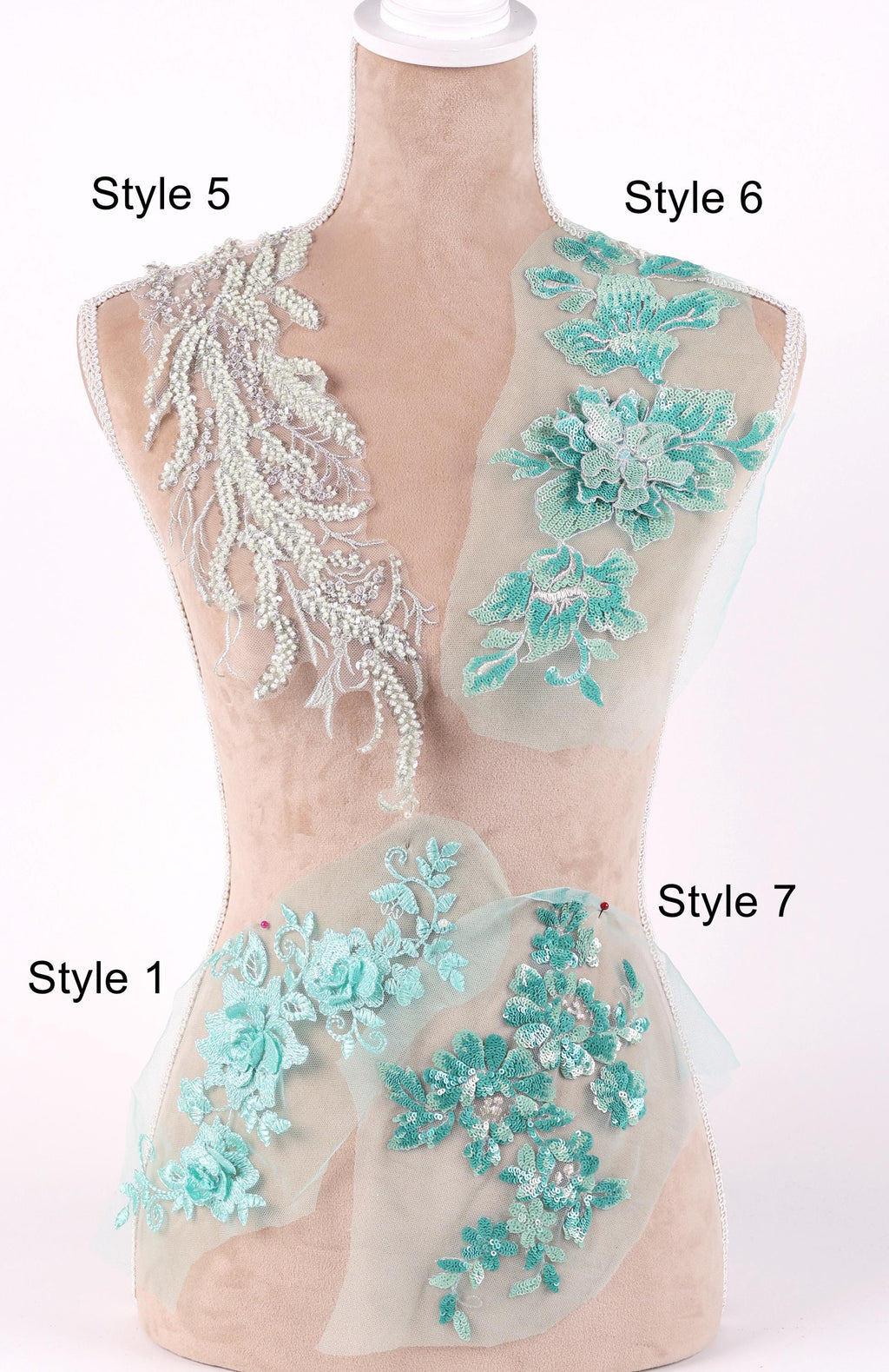 A mannequin with various styles of lace and floral embroidery displayed on its bust and hips.