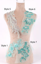 A mannequin with various styles of lace and floral embroidery displayed on its bust and hips.