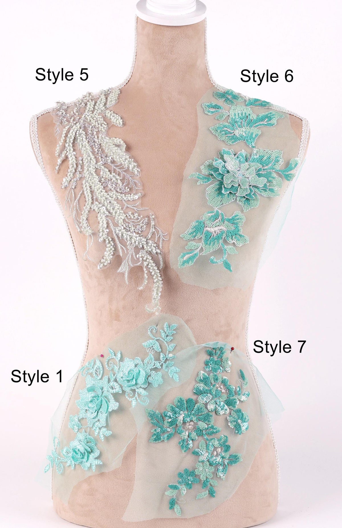 A mannequin with various styles of lace and floral embroidery displayed on its bust and hips.