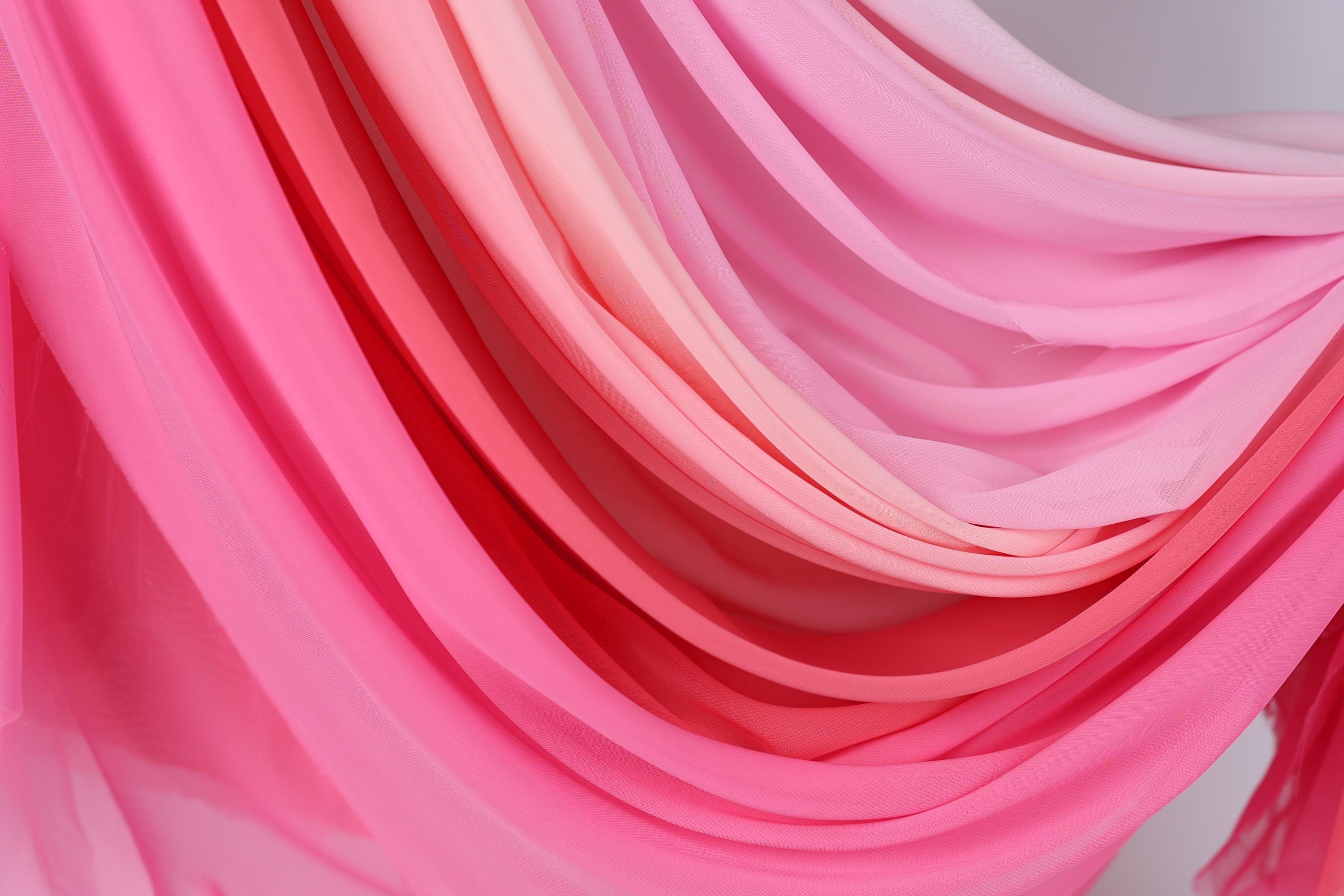 a close-up view of a fabric with a gradient of pink and red colors, creating a visually striking and vibrant appearance.