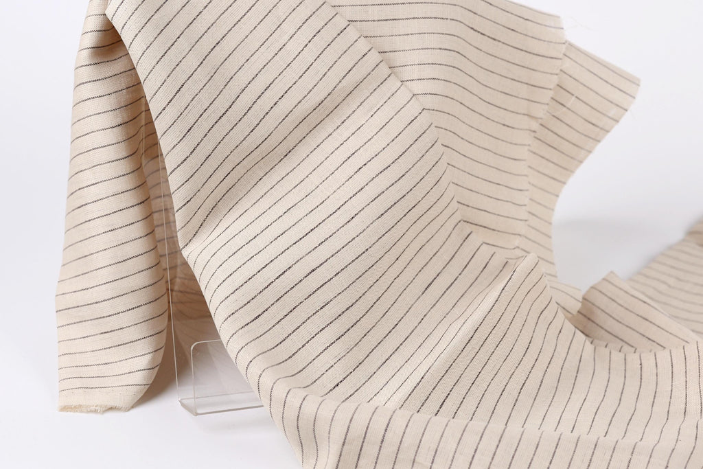 a close-up view of a fabric with horizontal black and white stripes, creating a textured and patterned appearance.