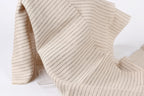 a close-up view of a fabric with horizontal black and white stripes, creating a textured and patterned appearance.