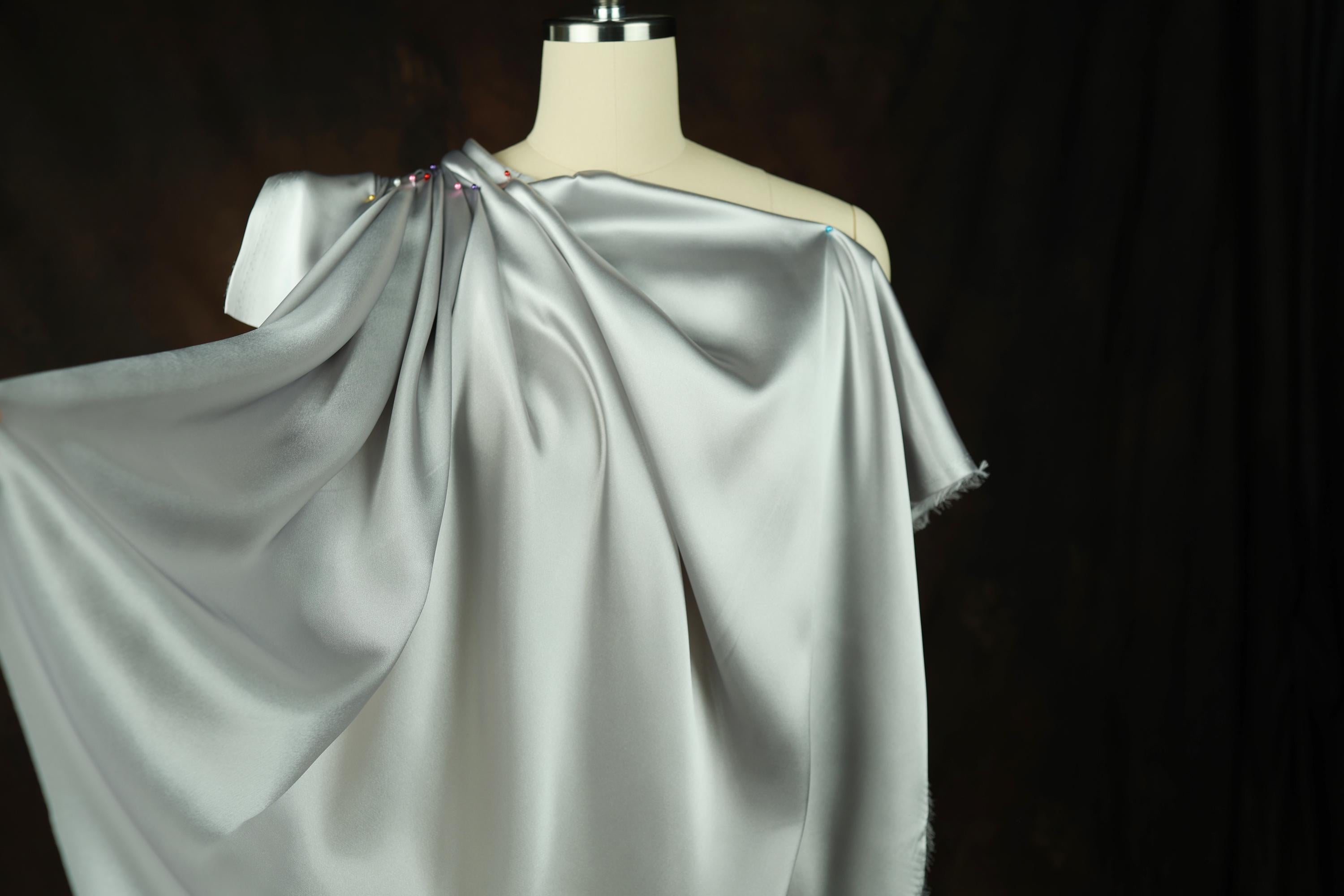 a dress on a mannequin on a black background