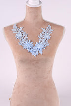A mannequin wearing a light blue floral necklace with delicate blue flowers.