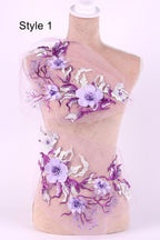A mannequin with a floral design on its torso, featuring purple and white flowers and leaves.