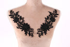 A mannequin torso with black floral embroidery on the bust area.