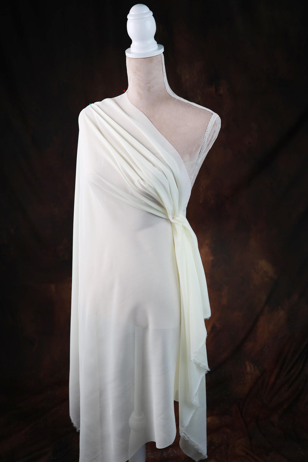 a white dress on a mannequin on a black background