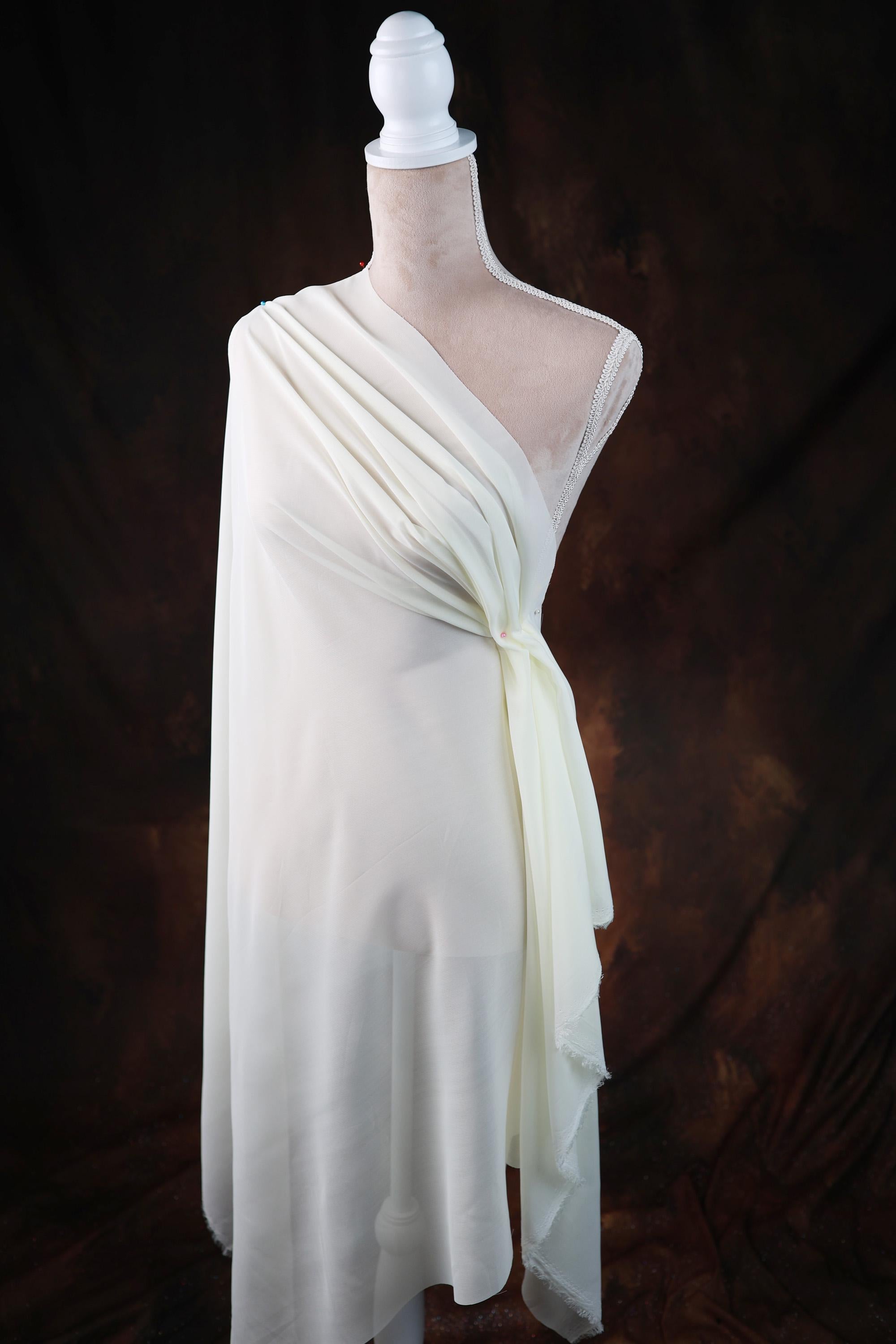 a white dress on a mannequin on a black background