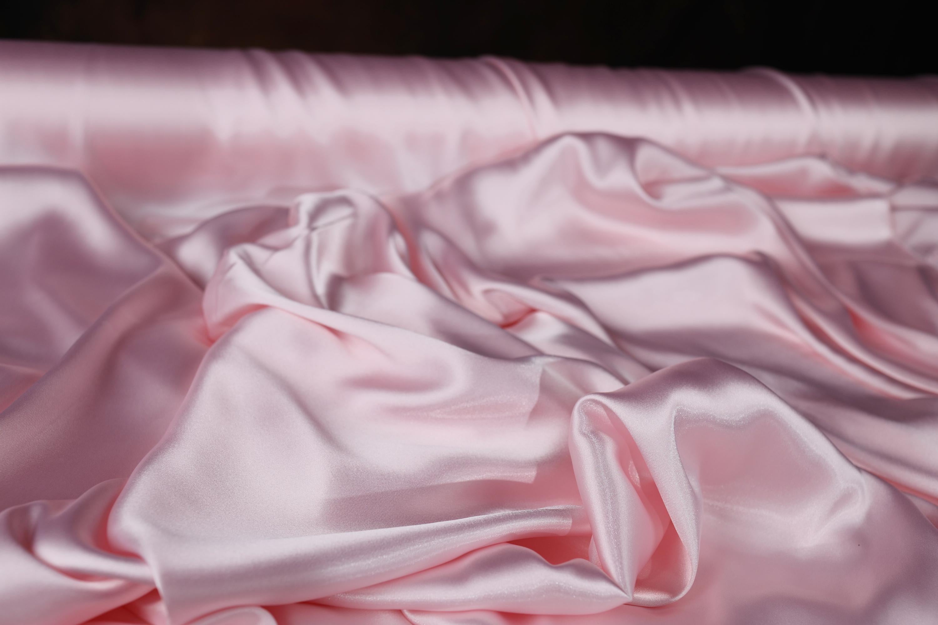 a close up of a pink satin material