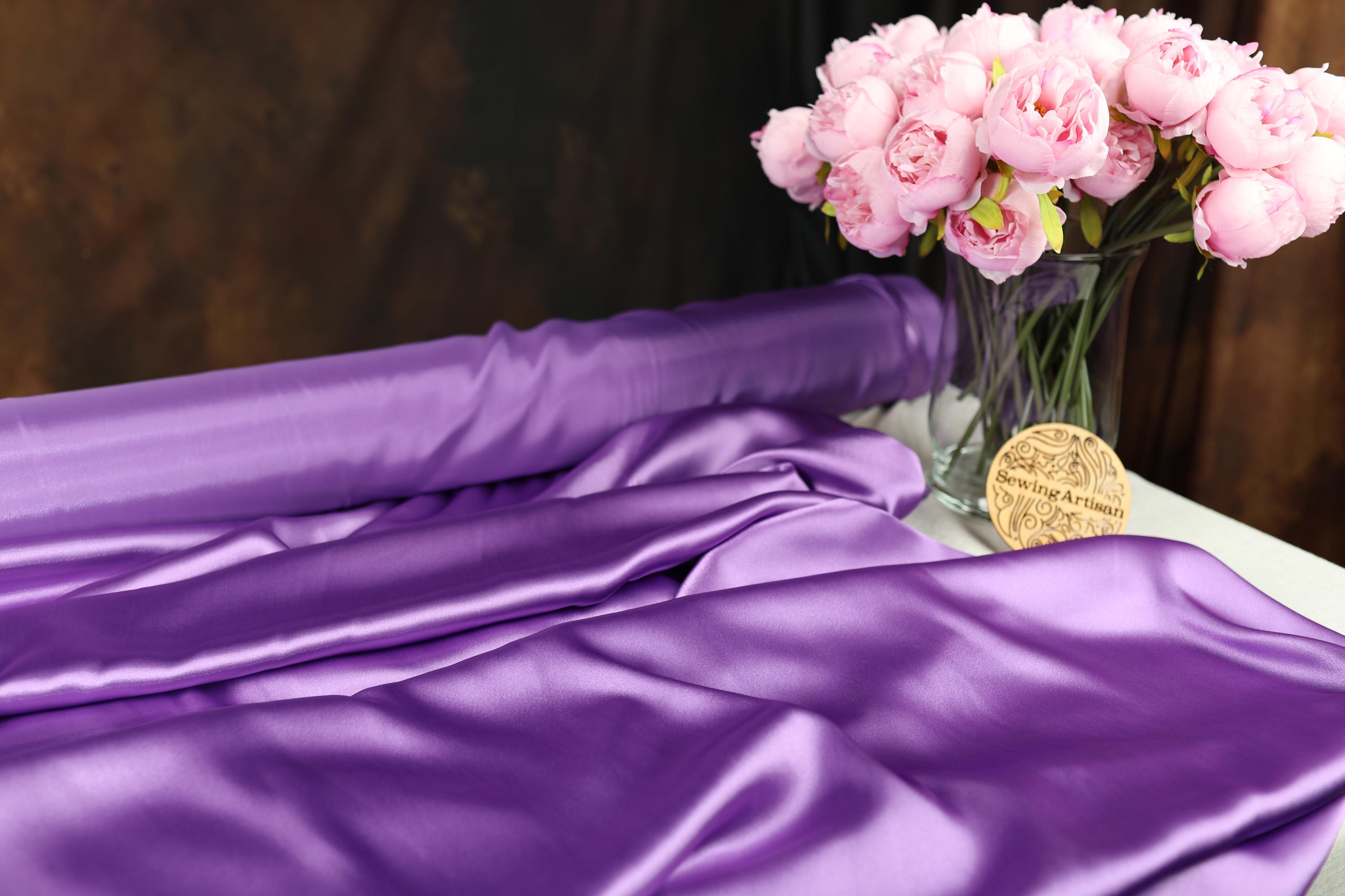 a vase filled with pink flowers on top of a table