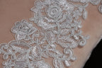 a close-up view of a delicate, intricate lace pattern on a fabric surface.