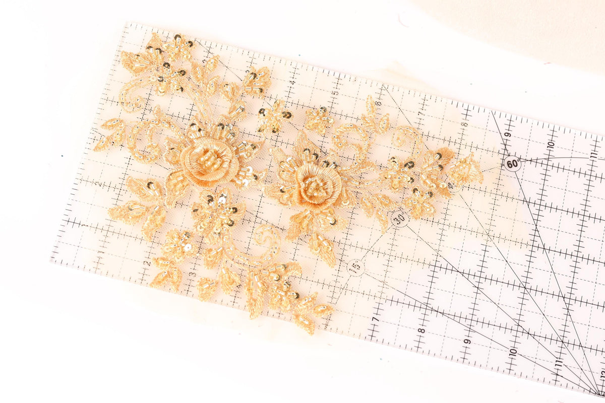 a clear ruler with gold floral designs on it.