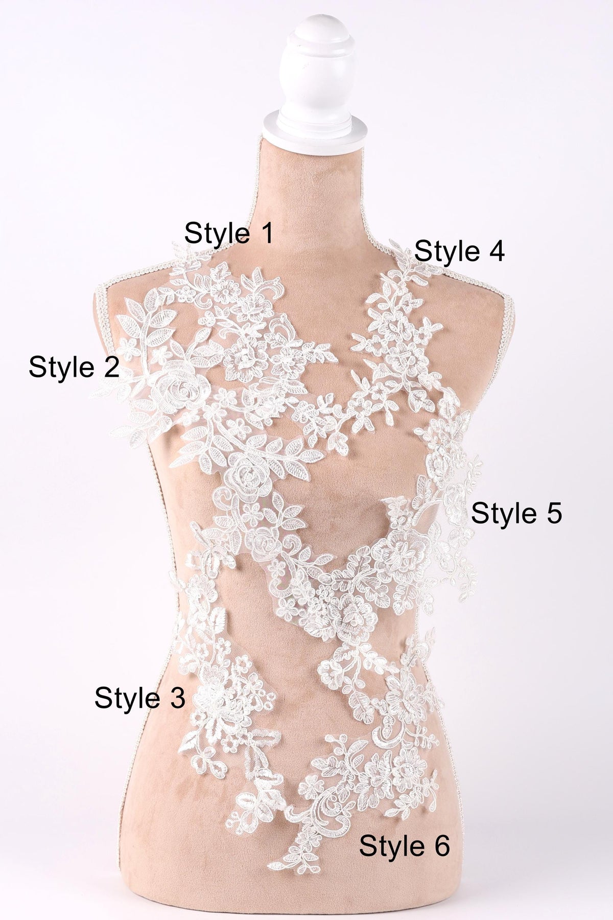 A mannequin with a white lace bodice and various lace patterns displayed on it, labeled with different styles.