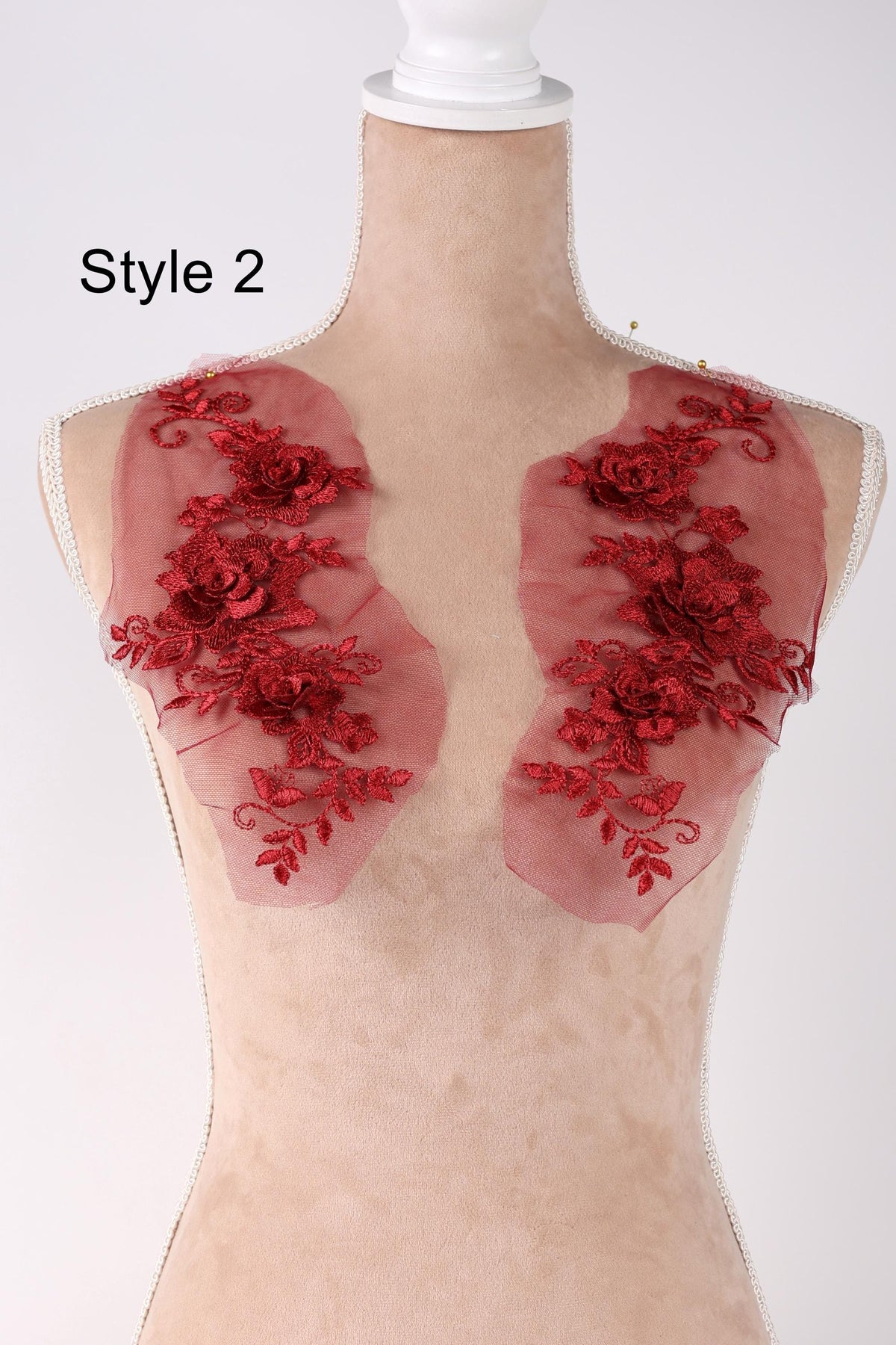 A mannequin with red floral embroidered fabric on its shoulders, labeled as "Style 2".