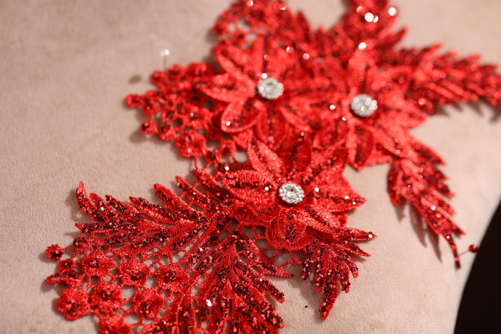 a close up of a pillow with red sequins on it