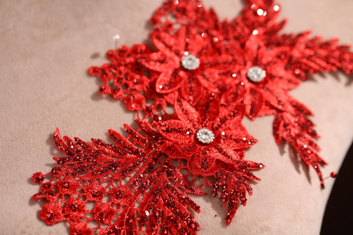 a close up of a pillow with red sequins on it