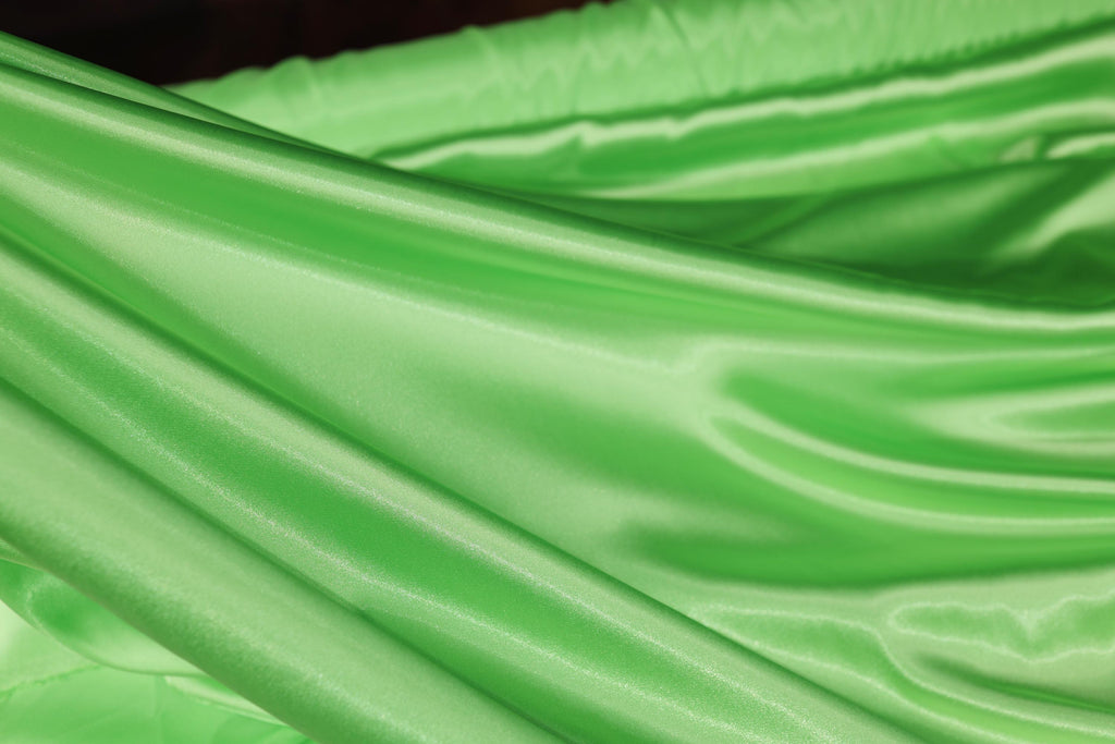a close up of a green satin material