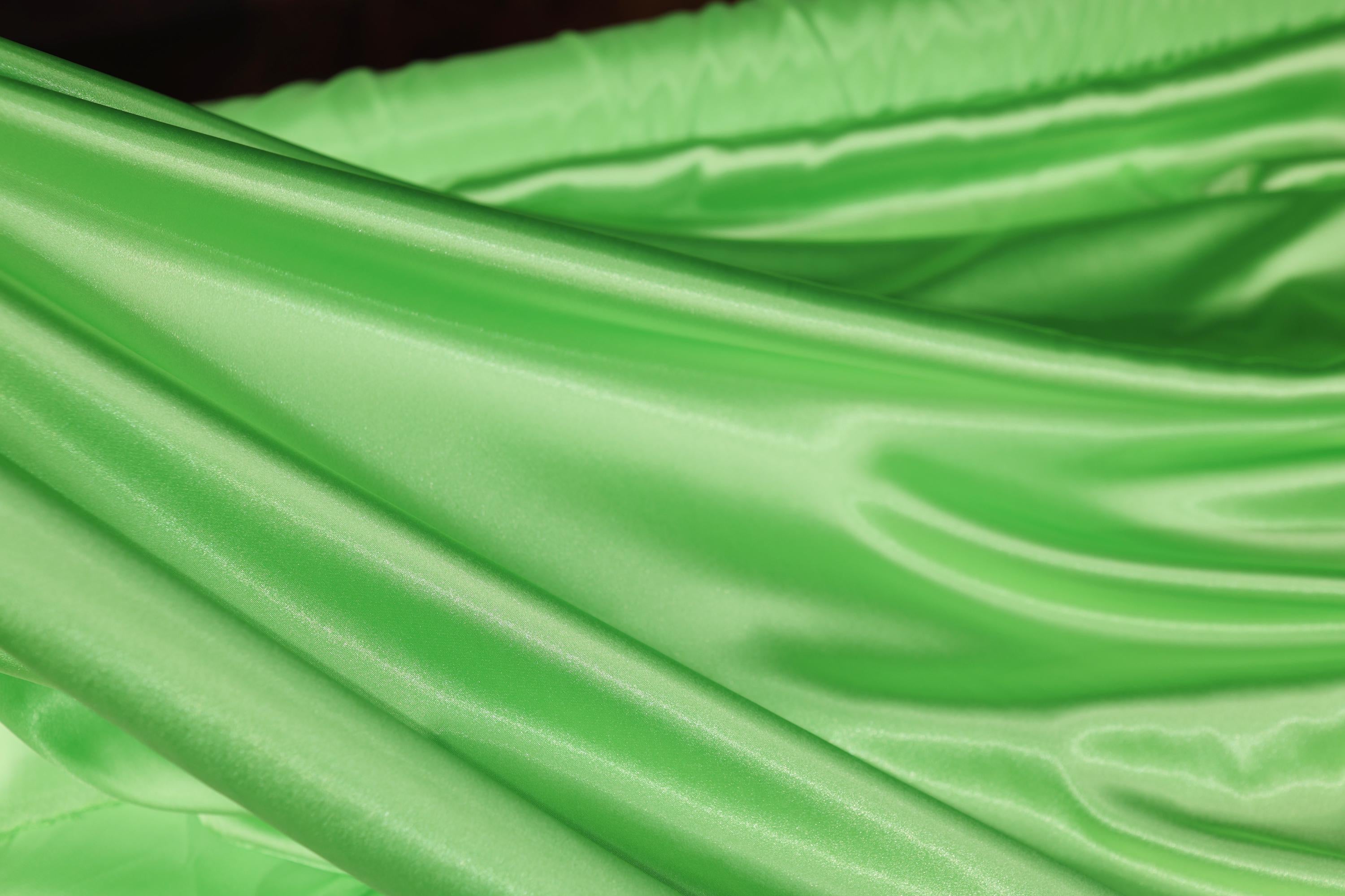 a close up of a green satin material