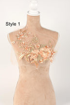 A mannequin with a floral design on its bust, featuring a combination of pink and peach flowers.