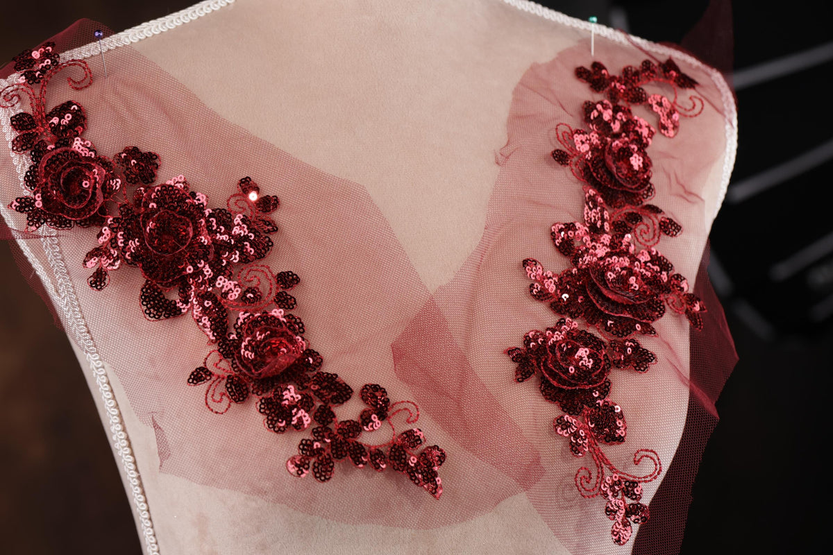 a pink dress with red flowers on it