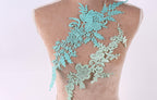 a mannequin torso with a decorative floral lace piece attached to it.
