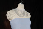 a white and blue dress on a mannequin